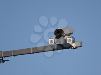 Security camera on blue sky background