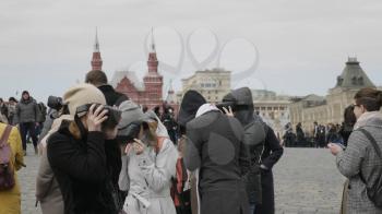 MOSCOW - MAY 27 2019: Excursion for tourists to historical places using VR helmets and virtual reality Moscow Kremlin on Red Square on May 27, 2019 in Moscow, Russia.