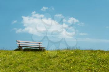 Bench on sky background. Tranquil scene.