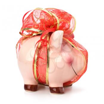 Christmas deposit concept. Piggy bank with festive bow isolated on white.