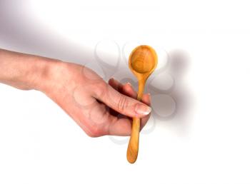 Hand holding wooden spoon isolated on white background