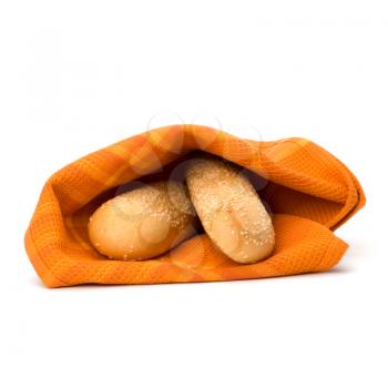 Fresh warm bread over kitchen towel isolated on white background