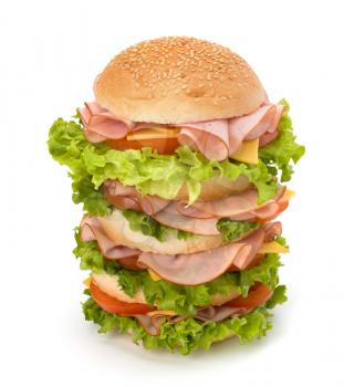 Big appetizing fast food sandwich with lettuce, tomato, smoked ham and cheese isolated on white background. Junk food hamburger.