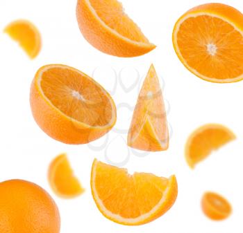 flying sliced orange fruit segments   isolated on white background
