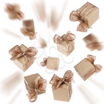 Flying gold gifts isolated on white background