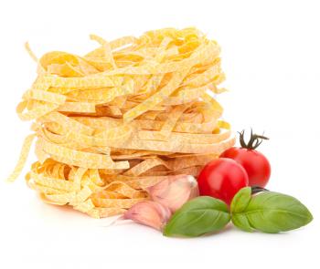 Italian pasta tagliatelle nest and cherry tomato isolated on white background