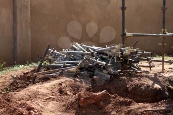 Royalty Free Photo of a Heap of Scaffolding Iron Pipes at Construction Site