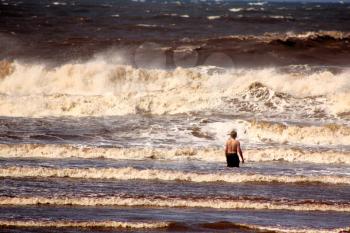 Lone Boy Standing in the Stormy Sea