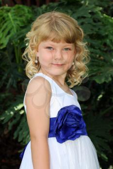 Adorable Little Blond Girl Posing in Dress with Ribbon  