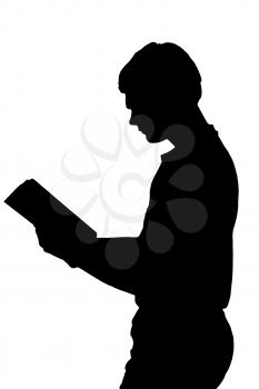 Side profile portrait silhouette of standing teenage boy reading a book