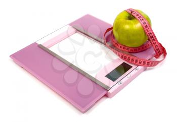 floor scales measuring ribbon and green apple isolated on white background