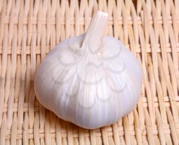 healthy white vegetable pungent garlic on background