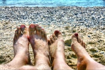 legs on sand of marine beach
