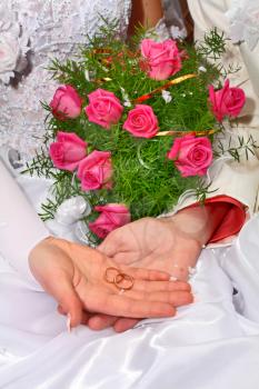 two wedding rings and bouquet for fiance and fiancee