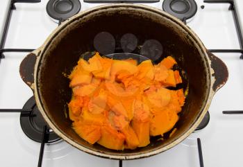 Cooked pumpkin in a cauldron on a gas cooker