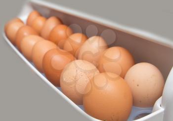 closeup of a pile of brown eggs in the fridge 