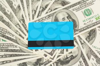 blue plastic card against dollar