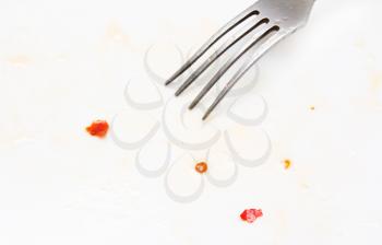 abstract background. pieces of chili with a fork on a white background