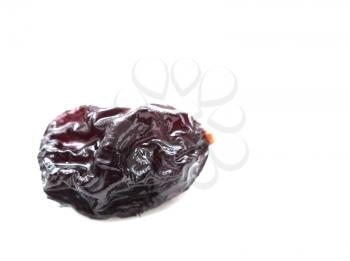 black raisins on a white background