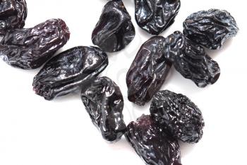 black raisins on a white background
