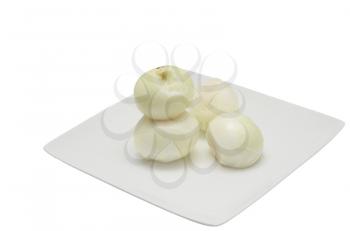 peeled onion in a dish on a white background
