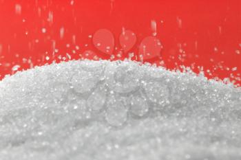 sugar on a red background. macro