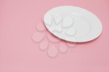 white plate on a pink background