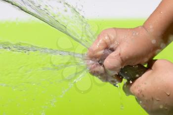 spray water from a hose child's hand