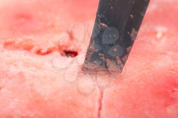 background of red watermelon with a knife. macro