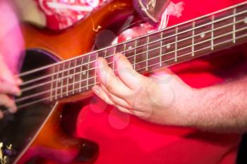 Musician playing guitar in a rock band .