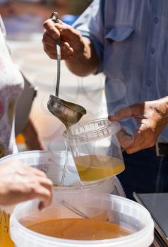 the beekeeper sells honey in the market .