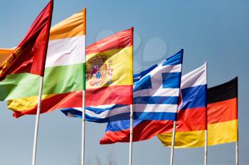 flags of different countries against the blue sky .