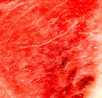 red ripe juicy watermelon in a cut as background .