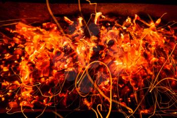 abstract background of burning coals of fire with sparks