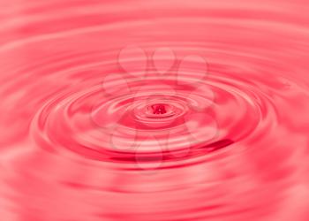 splashing water droplets on red background