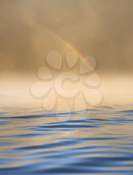 rainbow in the sky with reflection on water