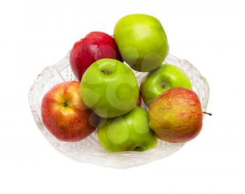 green and red apples in a crystal dish on a white background