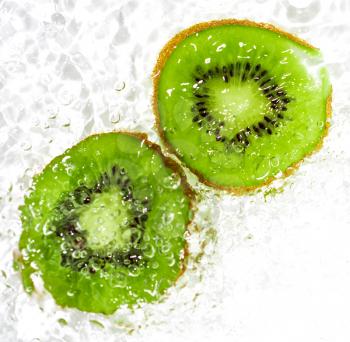 juicy kiwi fruit in water on a white background. macro