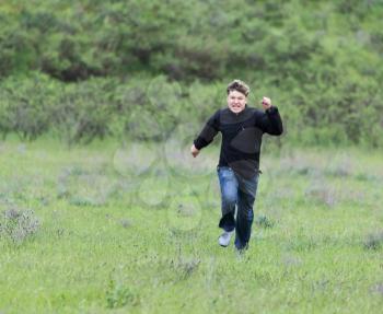 man running in a meadow