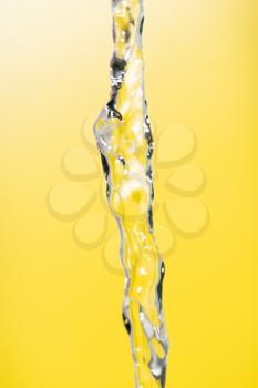 a jet of water on a yellow background