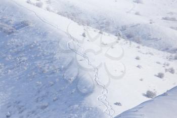 Trail of climbers on the snow in the mountains