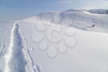 Trail in the snow in the mountains