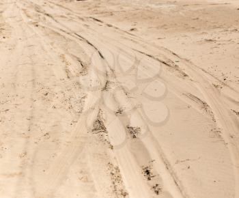 road in the sand on the lake