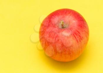 ripe apple on a yellow background