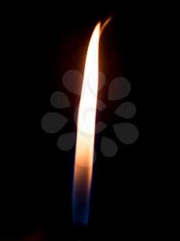 a flame of fire from the cigarette lighter on a black background