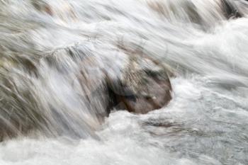 rough water in the mountain river water as a background