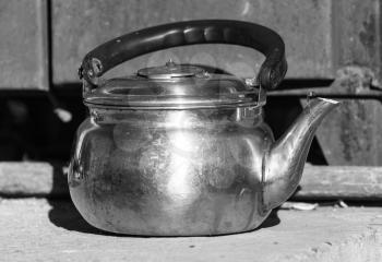photography still life old kettle placed on a wooden floor.