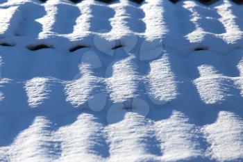 Snow on the roof of a house as a background