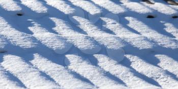 Snow on the roof of a house as a background