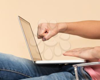 man in jeans with a laptop